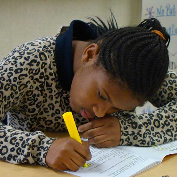 female student in classroom with highlighter